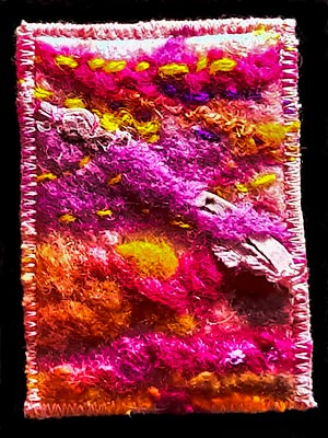 Artist trading card with brightly coloured fabric textures in pinks, oranges and yellows