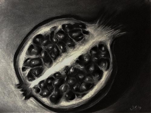 Charcoal drawing of a cut pomegranate on Arches paper