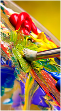 Brightly coloured thick paint being applied with a bristle paintbrush.