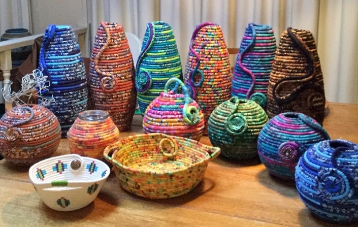 brightly coloured coiled fabric pots by Maggie Bush