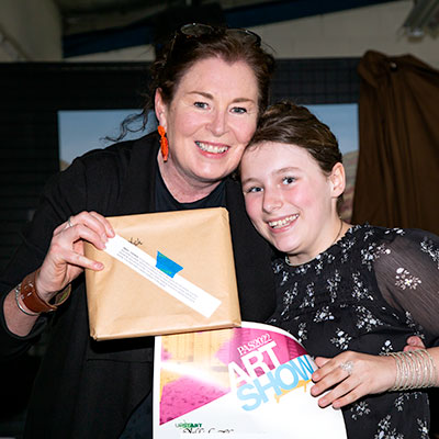 2022 Spring Art Show Childrens' Art Awards - tutor and child with award certificate