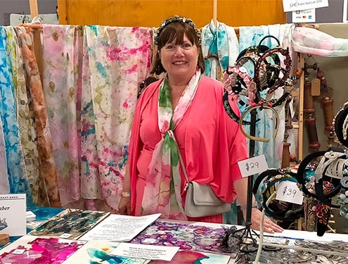 Jan Barbieri at Hastings Craft Expo with a selection of textile art