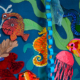 Children's art installation featuring brightly coloured undersea creatures against a painted undersea backdrop.