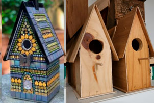 Sally Burns - Mosaic Bird Houses. Two bird houses in plain wood, and one covered in a multi-coloured mosaic tile pattern.