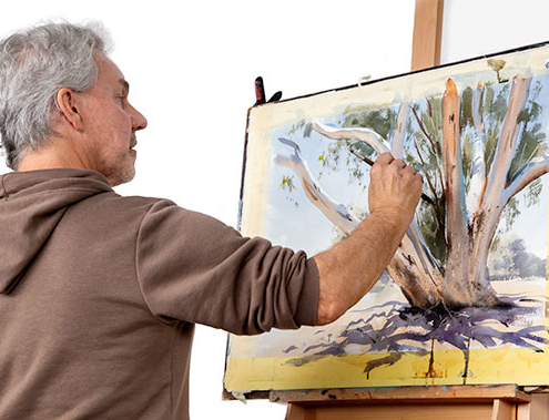 Greg Allen watercolour demonstration. Greg painting a white eucalypt tree at an easel.