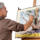 Greg Allen watercolour demonstration. Greg painting a white eucalypt tree at an easel.