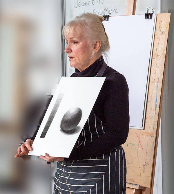 Jan Prislin Planinc explaining some fundamental drawing concepts with examples of a tonal scale and sphere.rendered in charcoal.