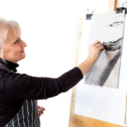 Jan Prislin-Planinc at an easel sketching in charcoal from the reference photo