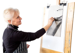 Jan Prislin-Planinc at an easel sketching in charcoal from the reference photo