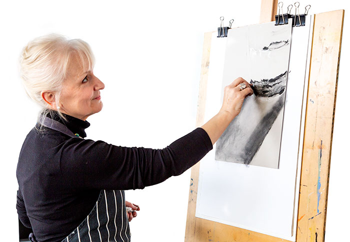 Jan Prislin-Planinc at an easel sketching in charcoal from the reference photo