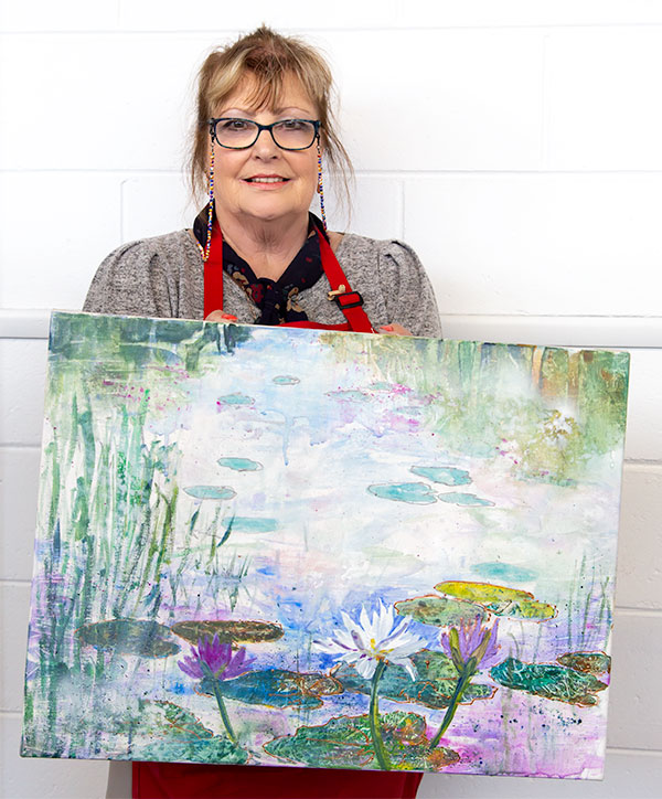 Julie with her completed painting of a watercolour pond