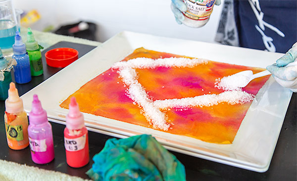 Salted sandwich technique - first layer dyed in warm yellows, oranges and pinks, with salt being sprinkled on top in stripes.