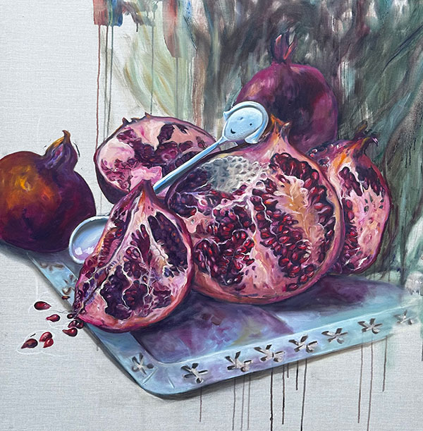 Claire Spring - still life of pomegranates and a silver spoon with a face on the handle
