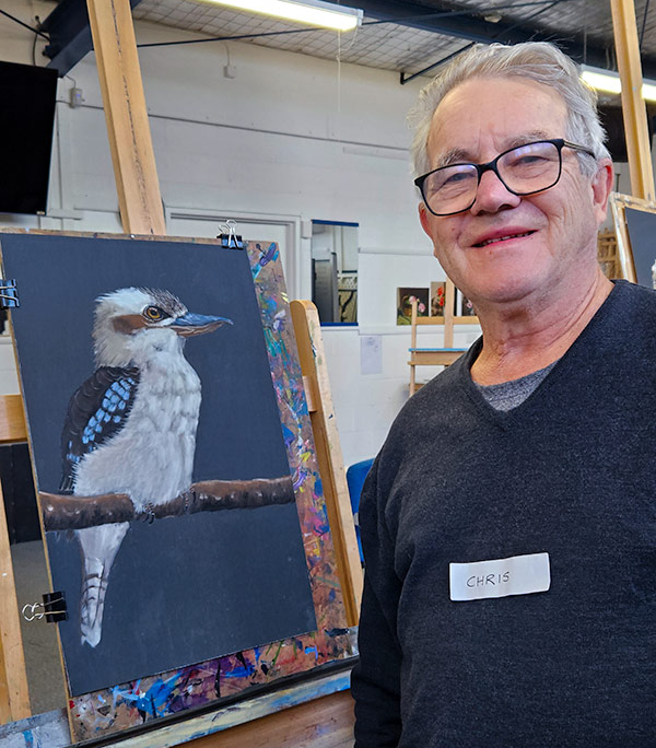 Angela Russo Pan Pastel Workshop - Chris- man holding pastel painting of a kookaburra