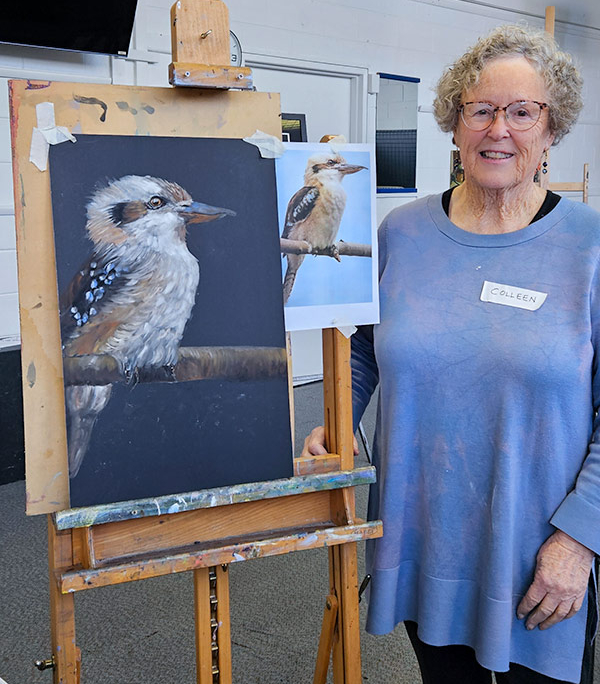 Angela Russo Pan Pastel Workshop - Colleen- woman holding pastel painting of a kookaburra.