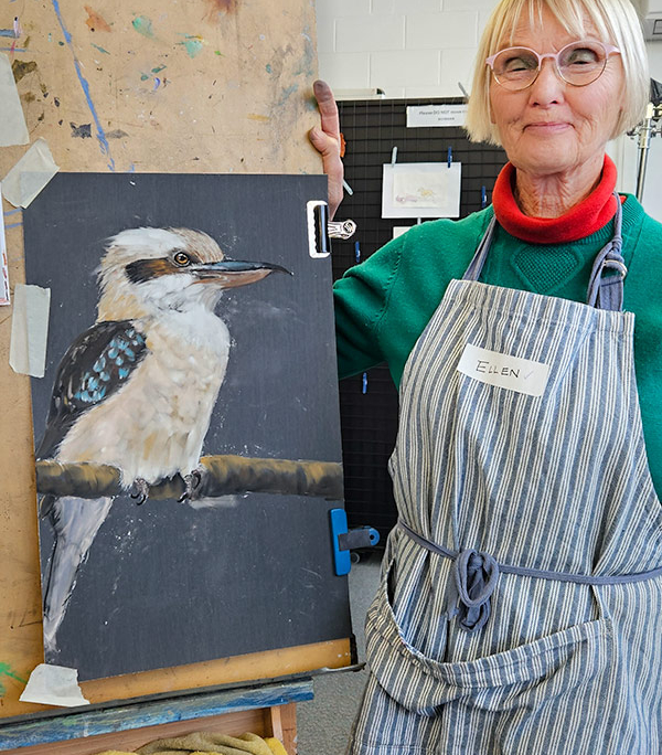 Angela Russo Pan Pastel Workshop - Eillen- woman holding pastel painting of a kookaburra.