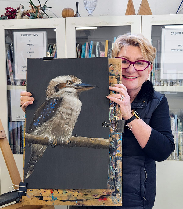 Angela Russo Pan Pastel Workshop - woman holding pastel painting of a kookaburra